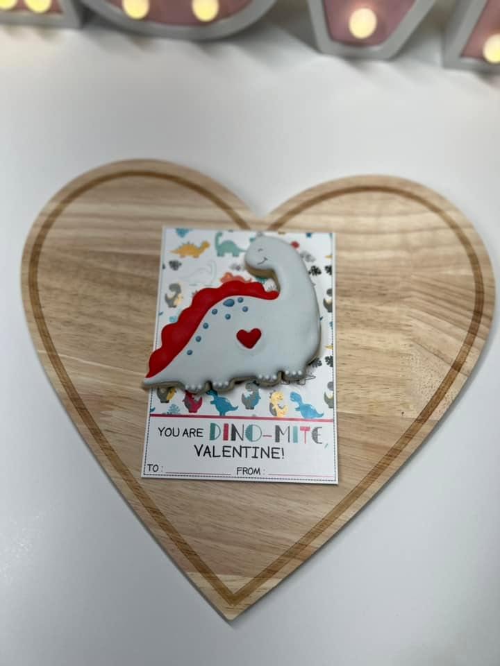Dinosaur cookie presented on a Valentine card